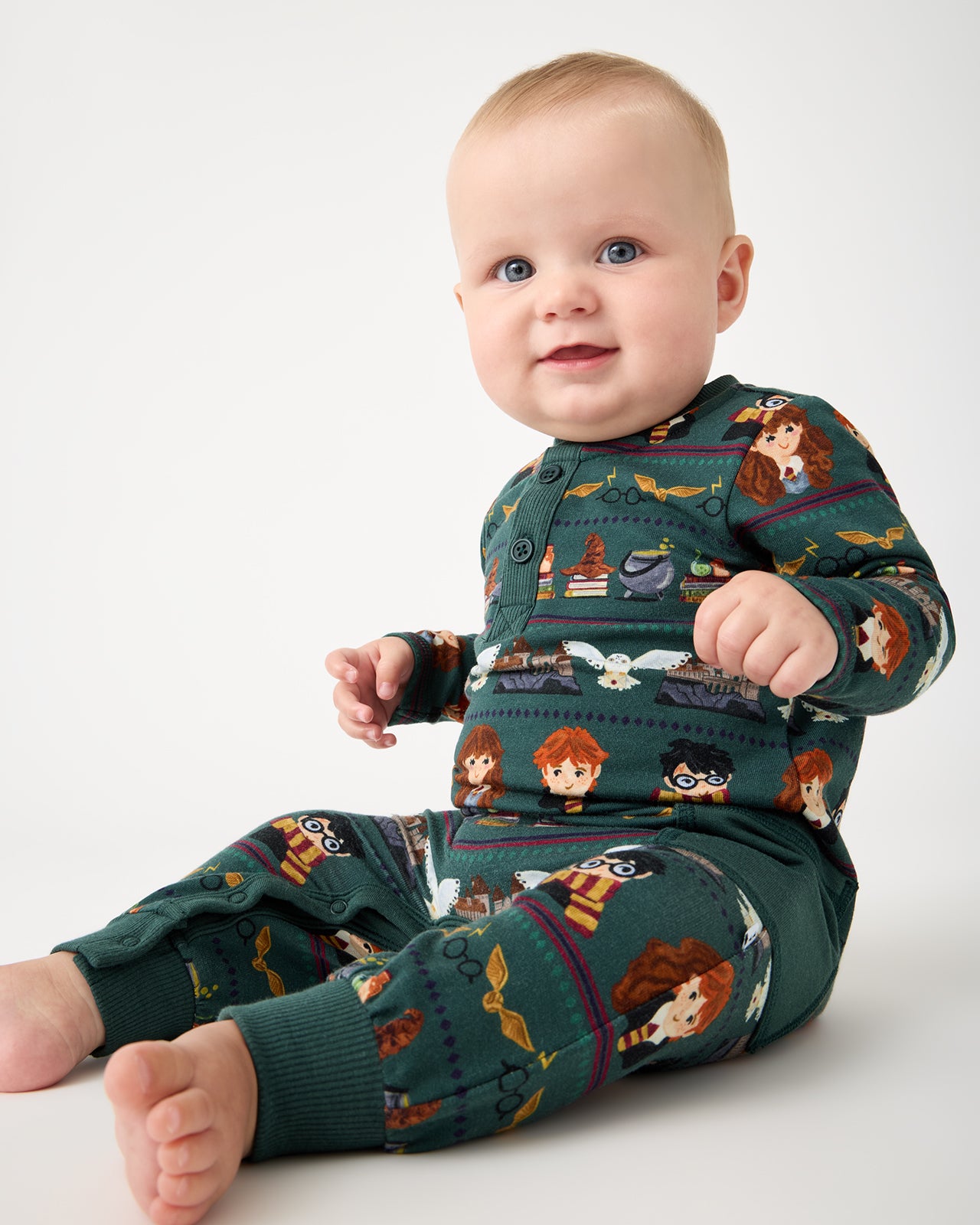 Sitting baby wearing the Harry Potter™ Spellbinding Studies Henley Romper