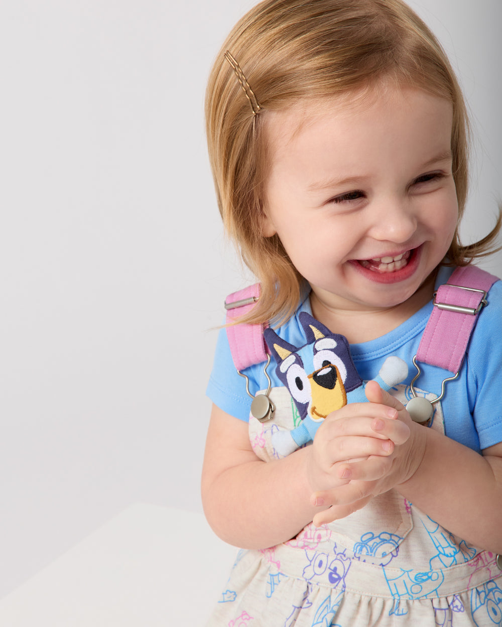 Close up of toddler wearing the Bluey Playtime Crew Skirt Overall