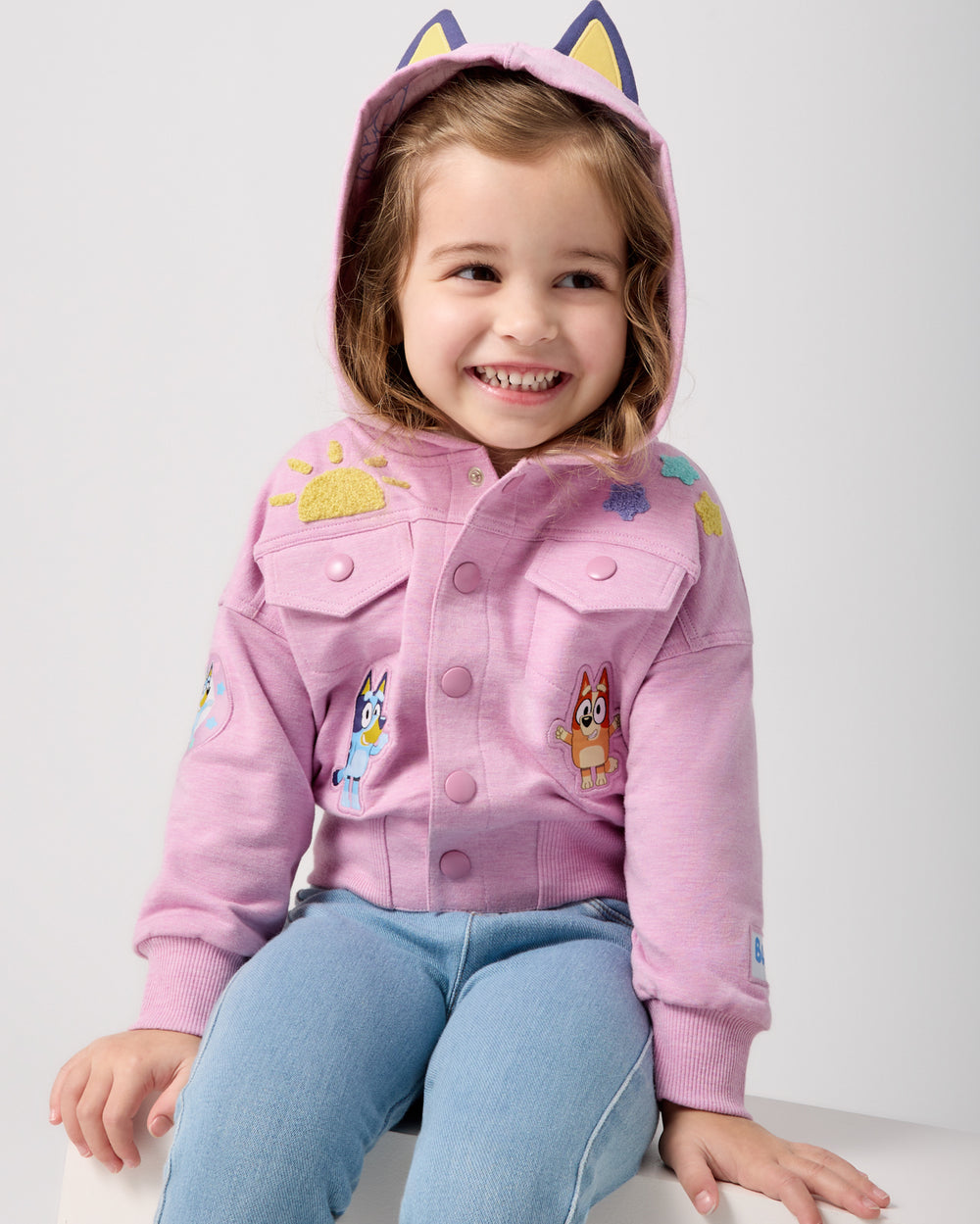 Girl wearing the Bluey Friends Forever Hooded Trucker Jacket with denim pants