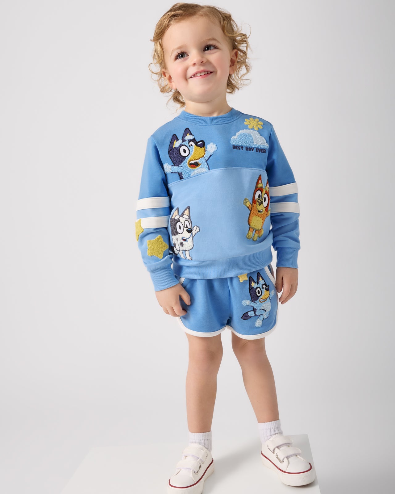 Child wearing the Bluey Best Day Ever Crewneck Sweatshirt and Shorts