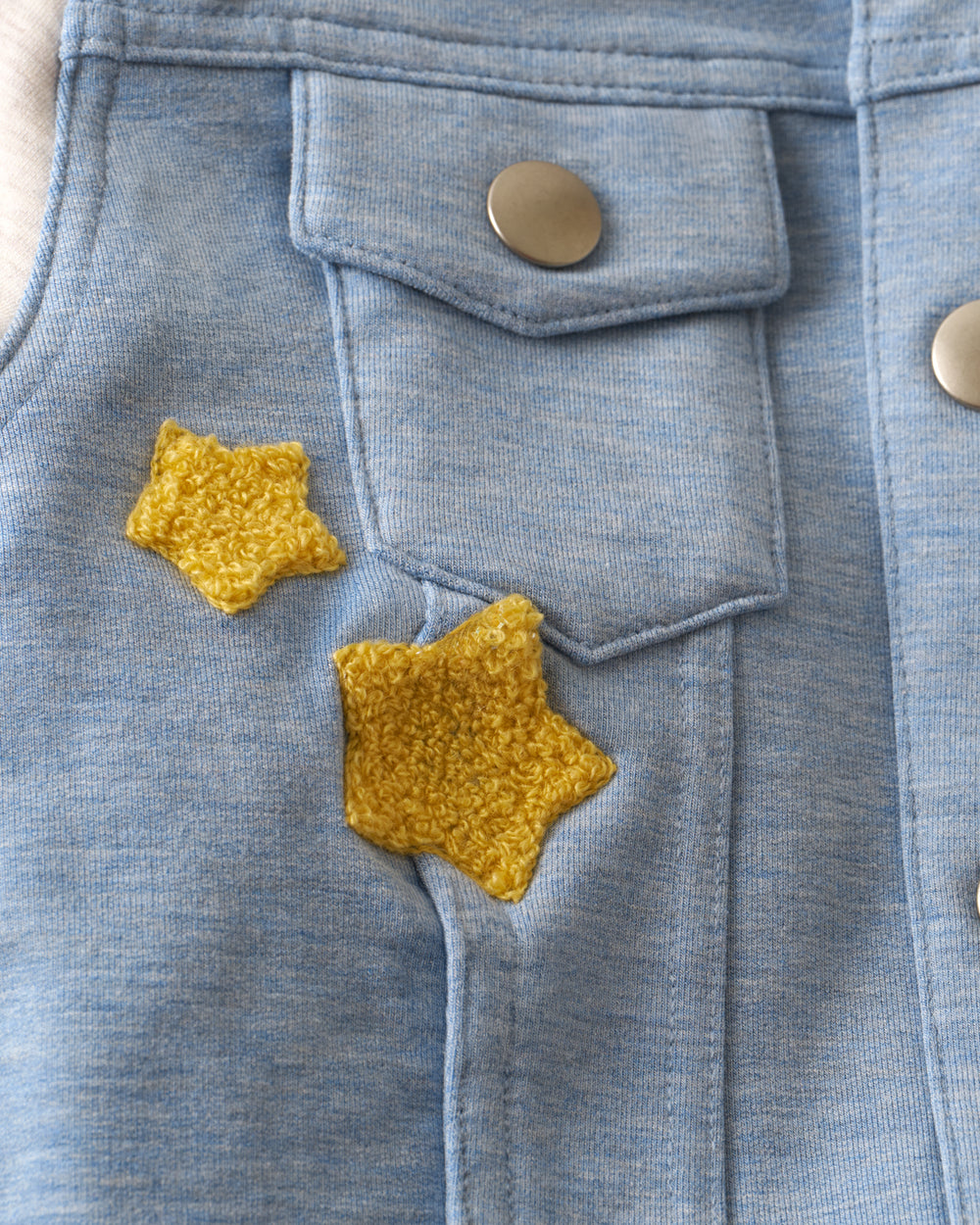 Close up of the chest pocket detail on the Bluey Hooded Trucker Jacket