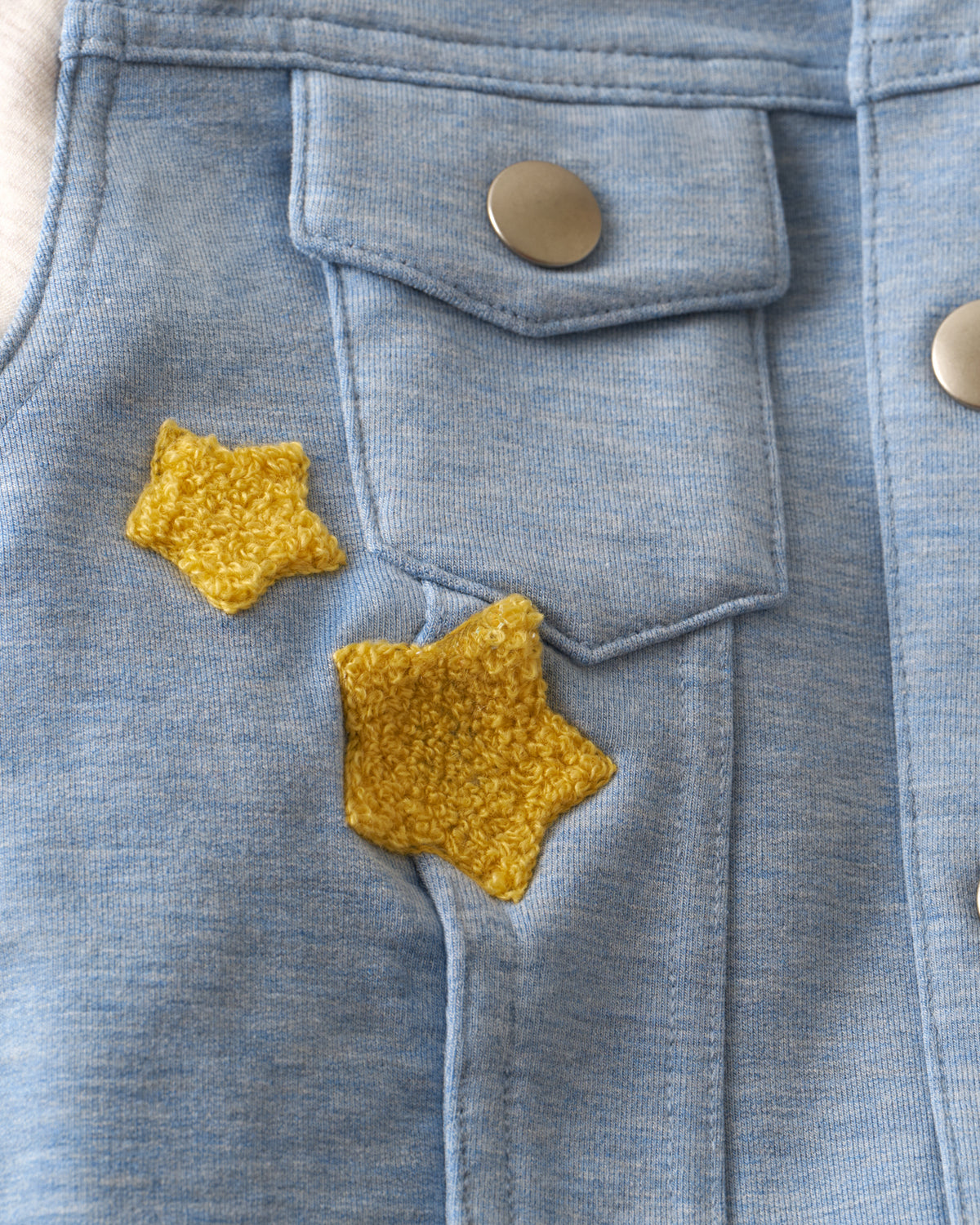 Close up of the chest pocket detail on the Bluey Hooded Trucker Jacket