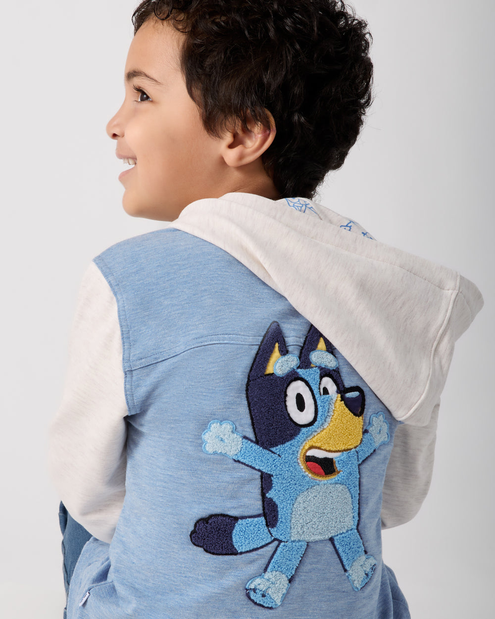 Back view of boy wearing the Bluey Hooded Trucker Jacket