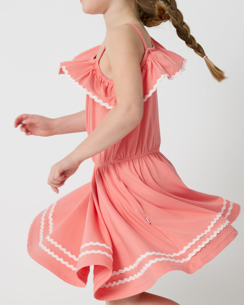 Twirling girl wearing the Beach Coral Asymmetrical Dress