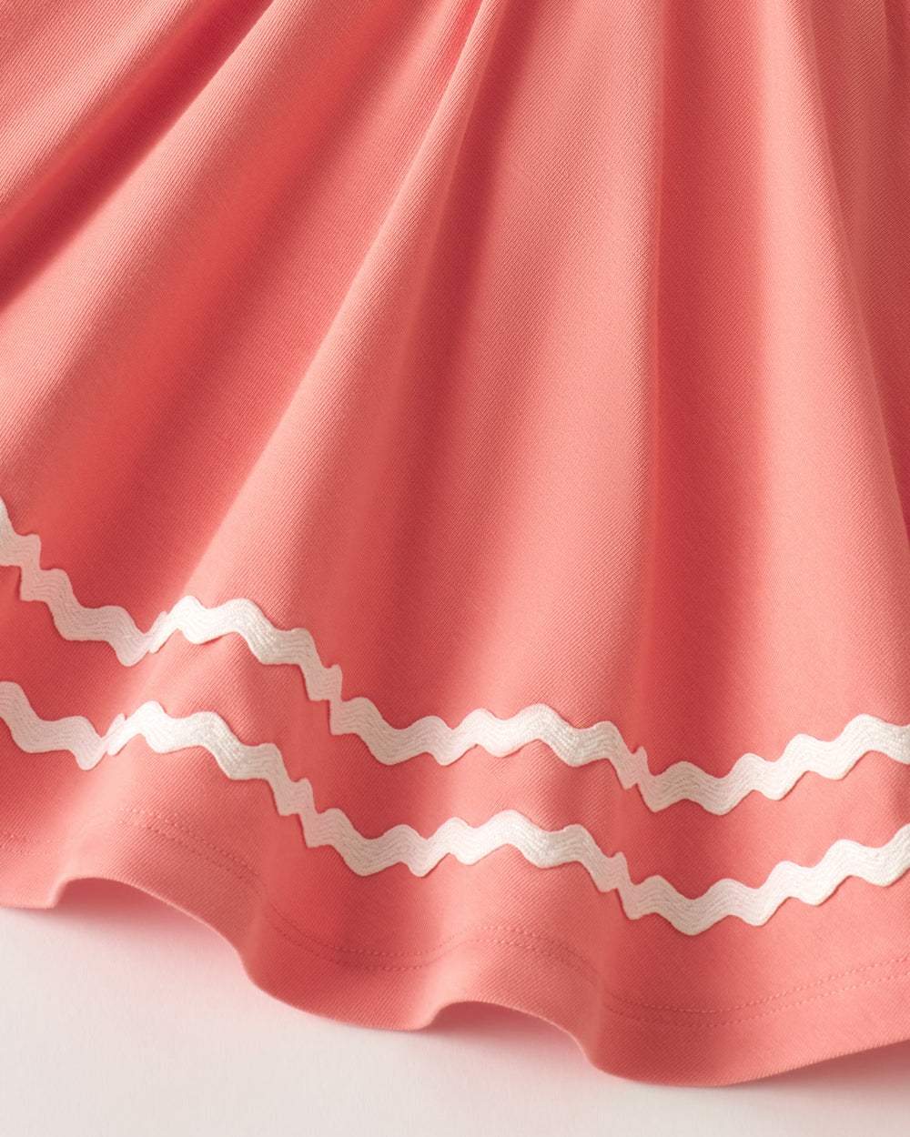 Close up of the trim detail on the Beach Coral Smocked Top with Bloomer