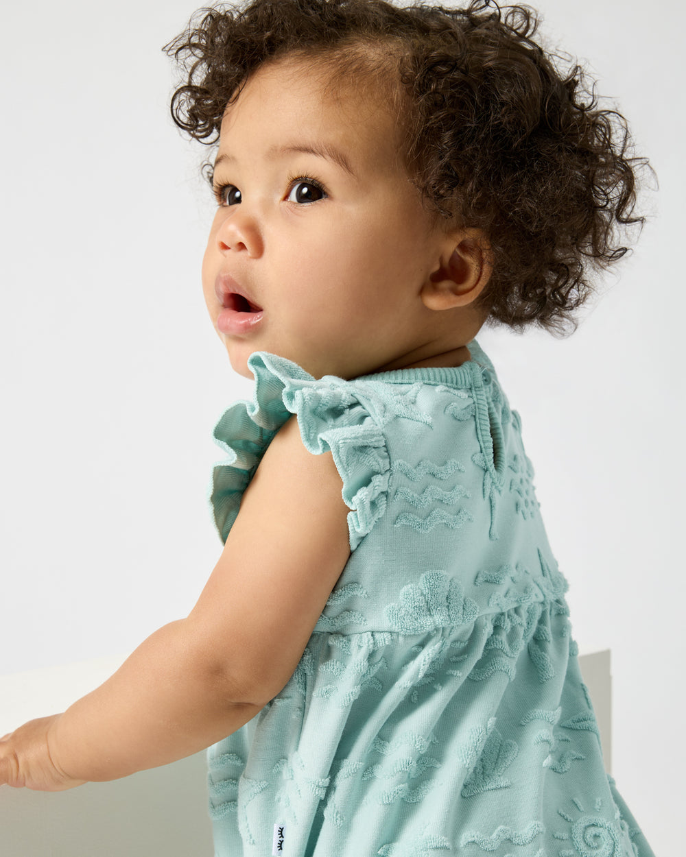 Close up of the flutter detail on the Coastal Rays Flutter Bodysuit