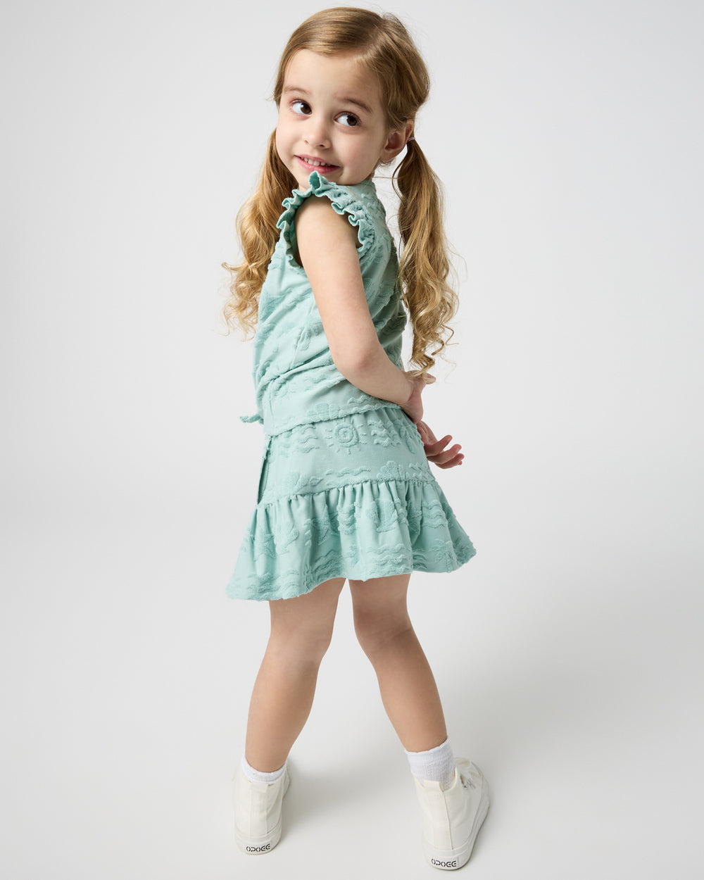 Girl wearing the Coastal Rays Flounce Skort with a matching top
