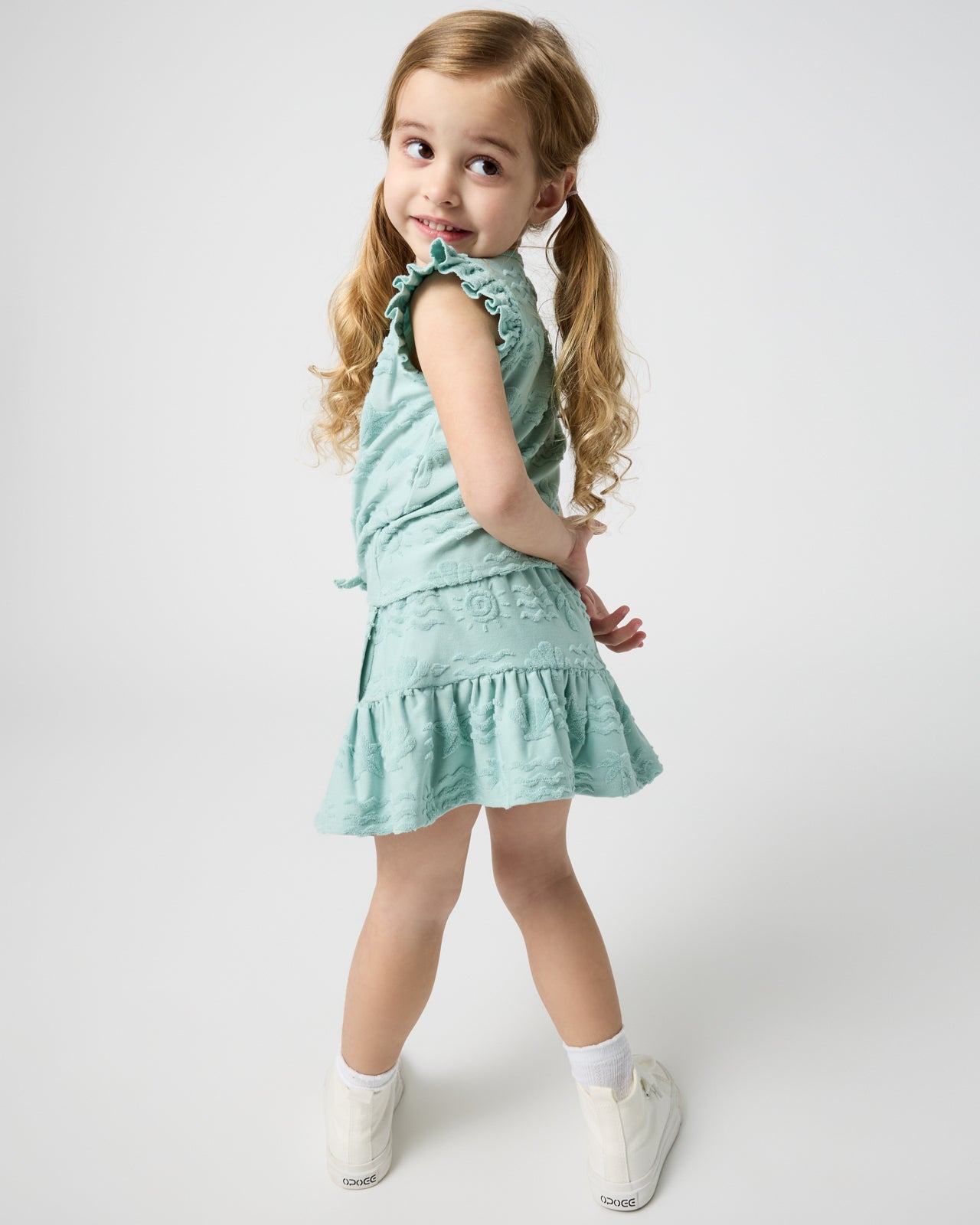 Girl wearing the Coastal Rays Flounce Skort with a matching top