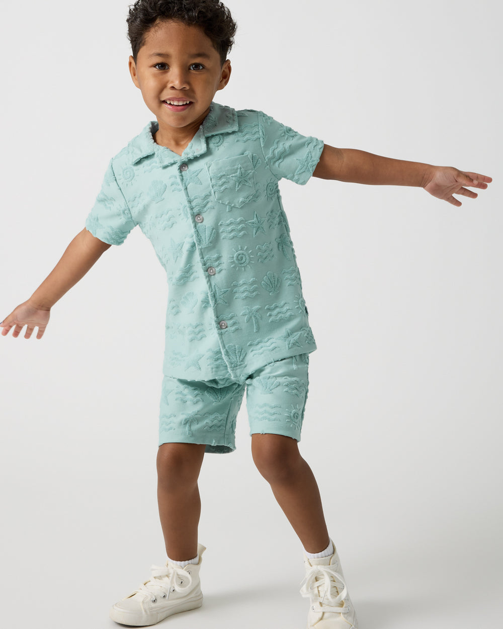Posing boy wearing the Coastal Rays Drawstring Shorts