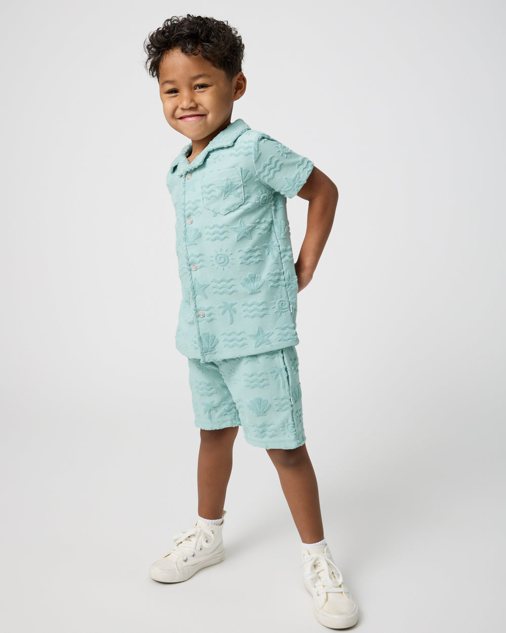 Standing child wearing the Coastal Rays Button Down Polo and Shorts