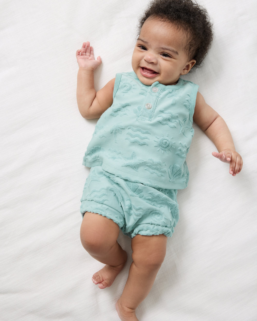 Aerial view of baby wearing the Coastal Rays Henley Tank Set