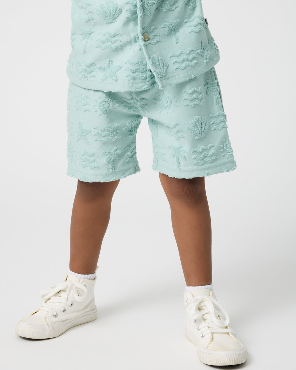 Front view of boy wearing the Coastal Rays Drawstring Shorts