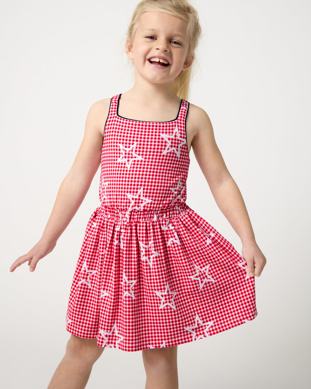 Close up of girl wearing the Celebration Gingham Bow Back Twirl Dress