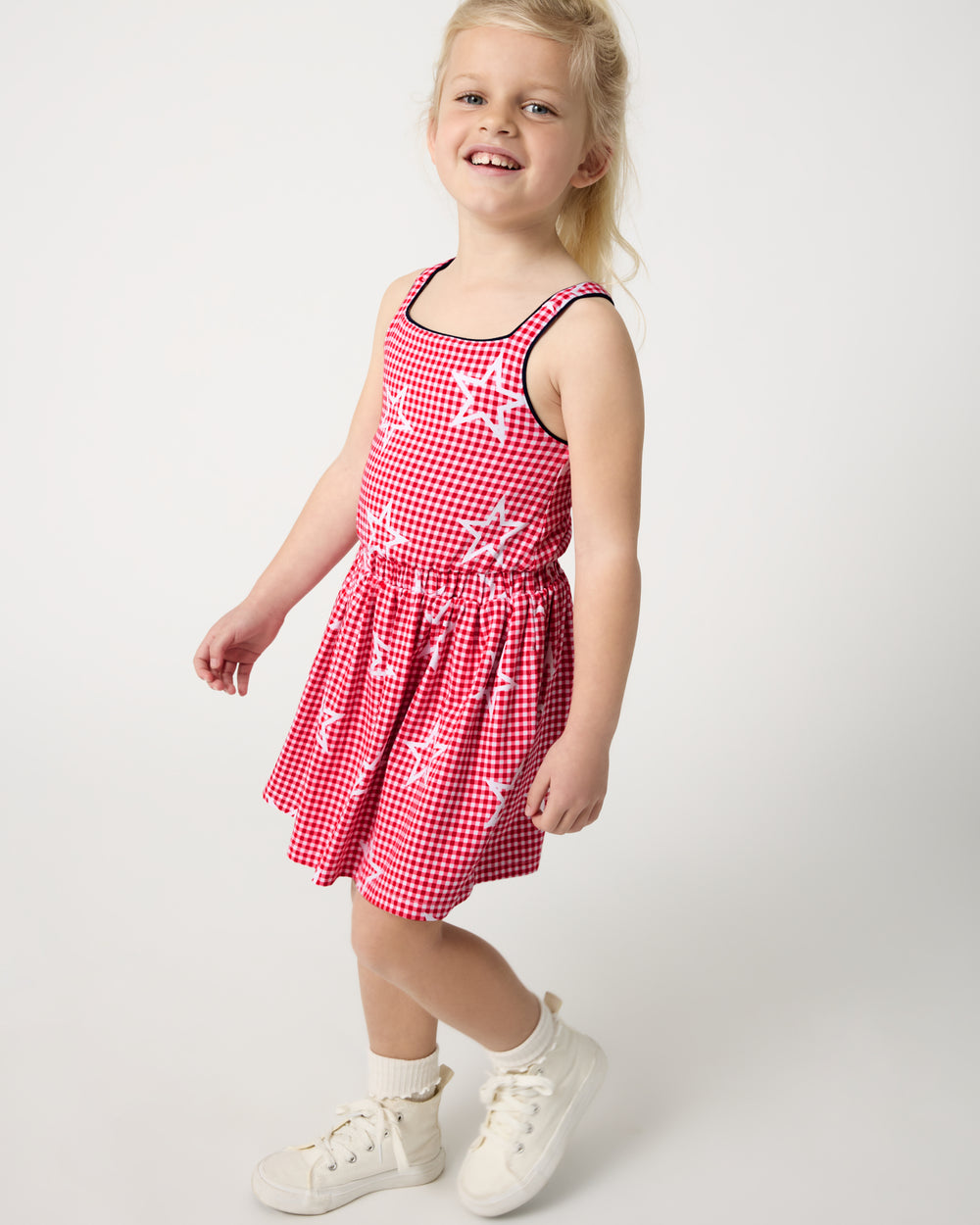 Girl wearing the Celebration Gingham Bow Back Twirl Dress