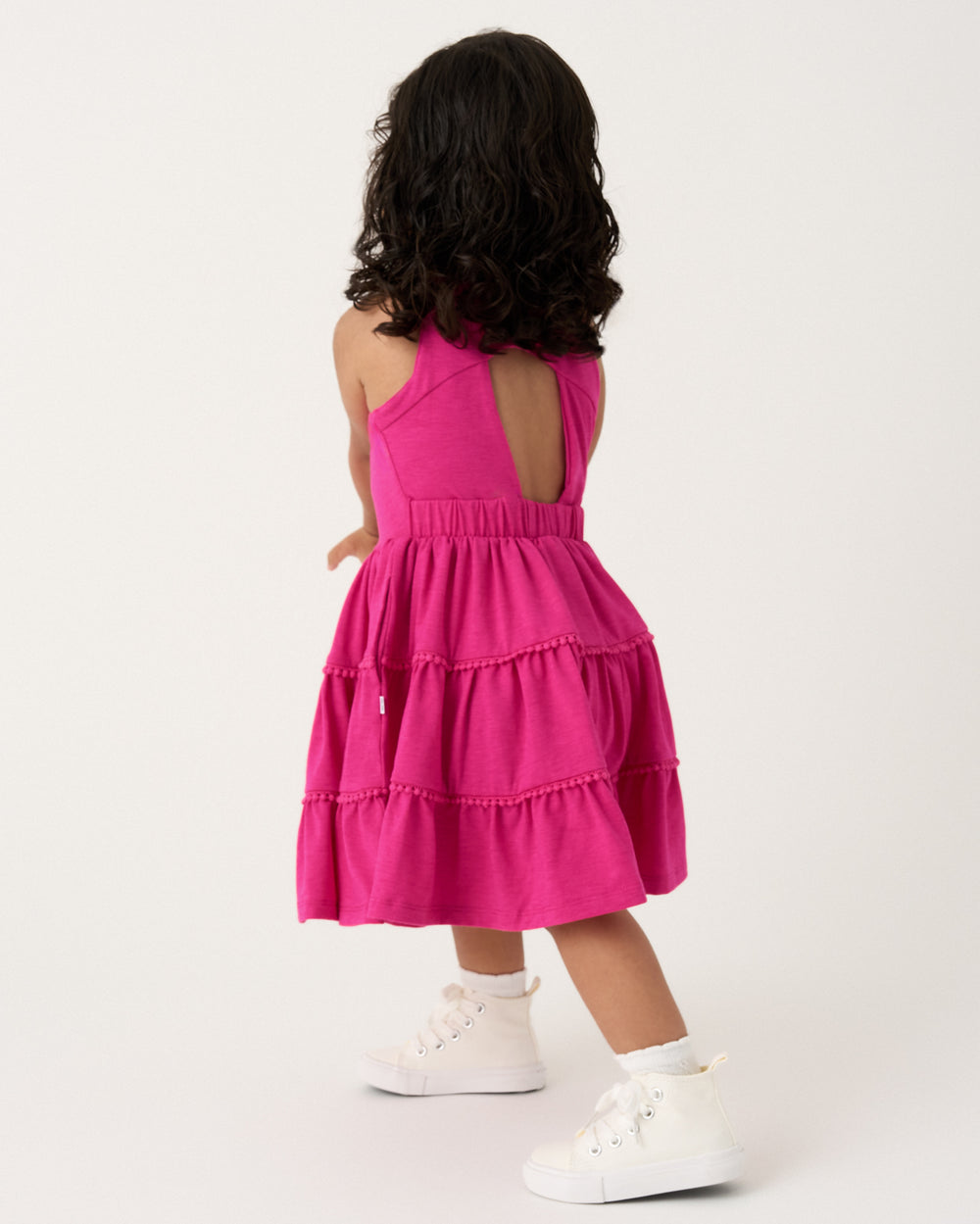 Back view of girl wearing the Pink Punch Open Back Tiered Dress