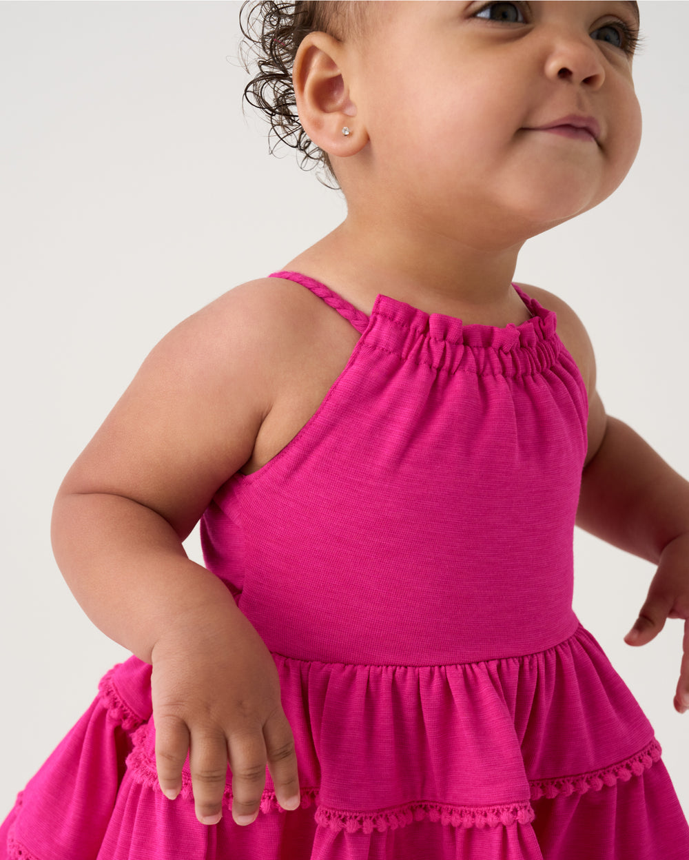 Close up of baby wearing the Pink Punch Open Back Tiered Dress with Bloomer