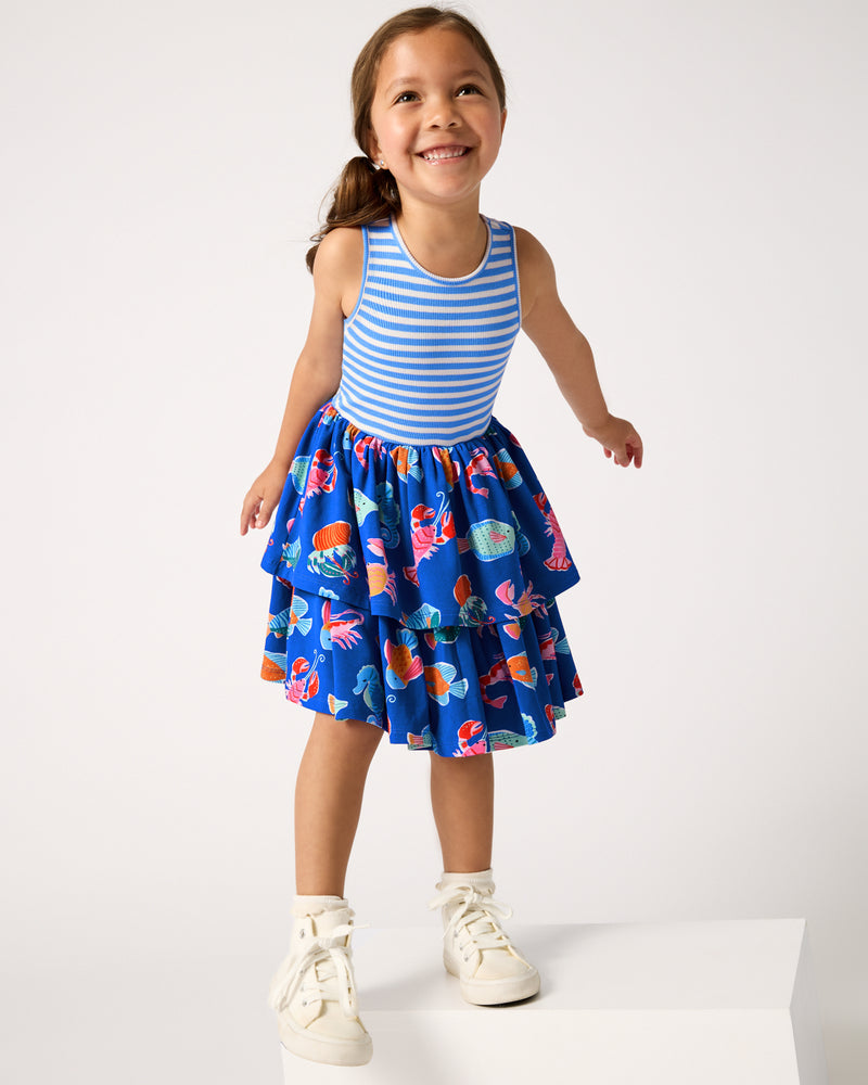 Girl wearing the Tidepool Party Tiered Dress with white sneakers