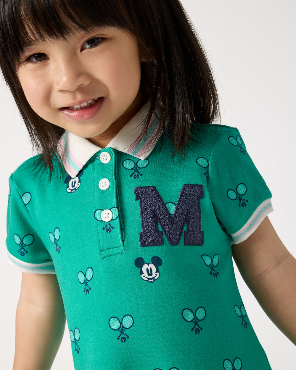 Close up of girl wearing the Disney Mickey Mouse Racket Rally Drop Waist Dress