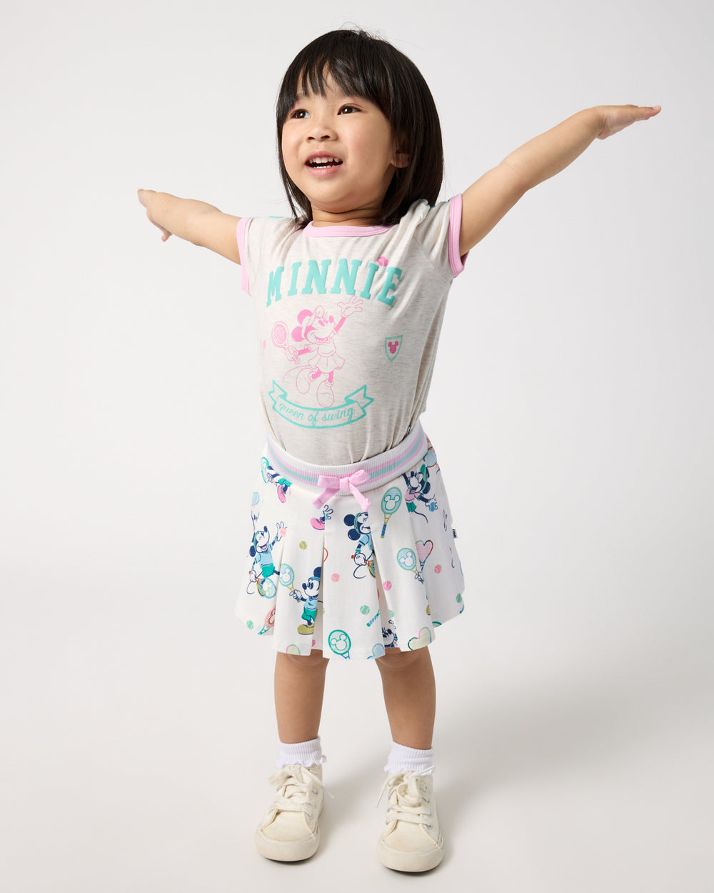Girl wearing the Disney Minnie Mouse Queen of Swing Ringer Tee and Skirt