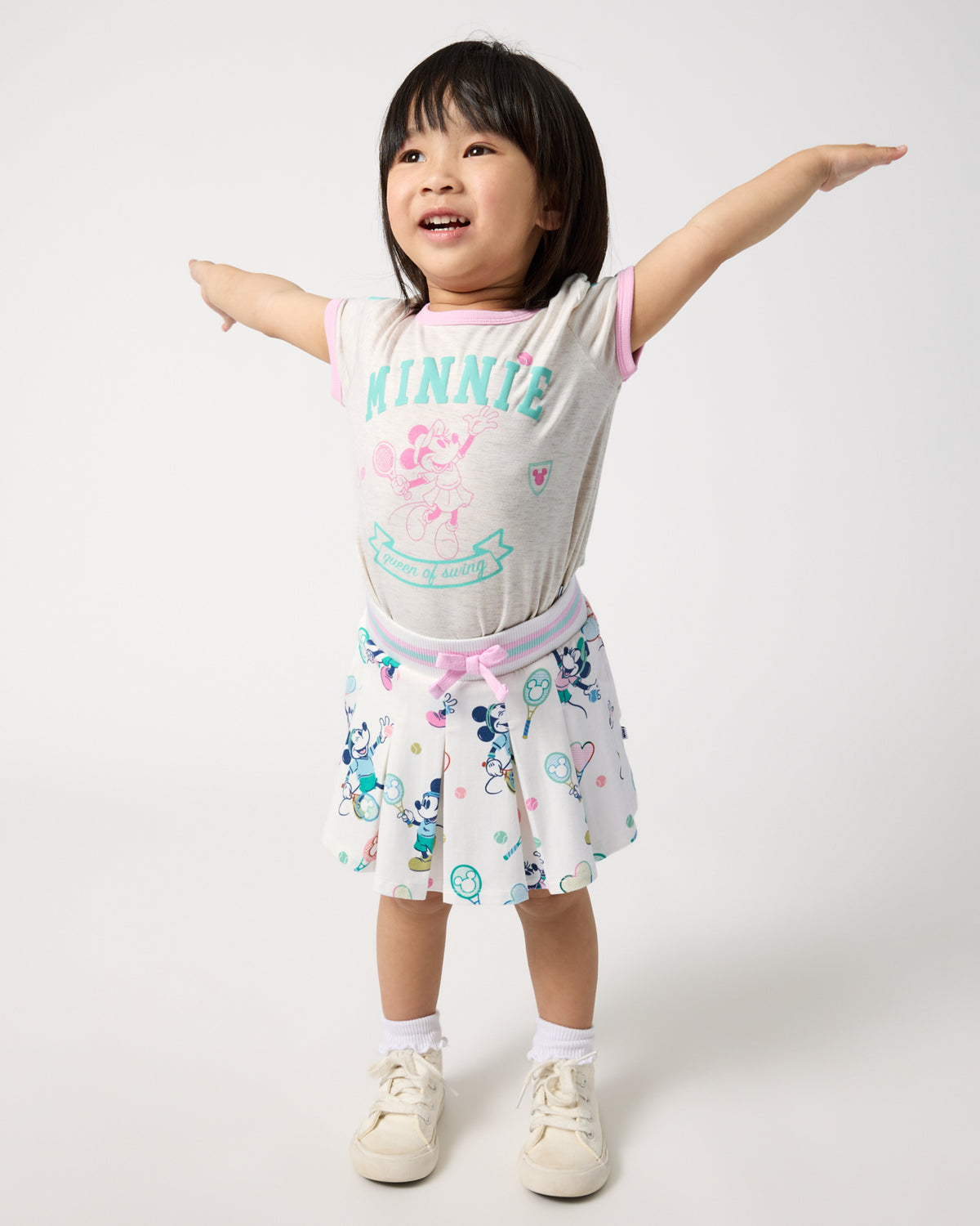 Girl wearing the Disney Minnie Mouse Queen of Swing Ringer Tee and Skirt