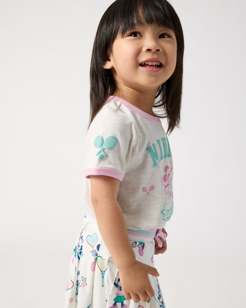Side view of child wearing the Disney Minnie Mouse Queen of Swing Ringer Tee
