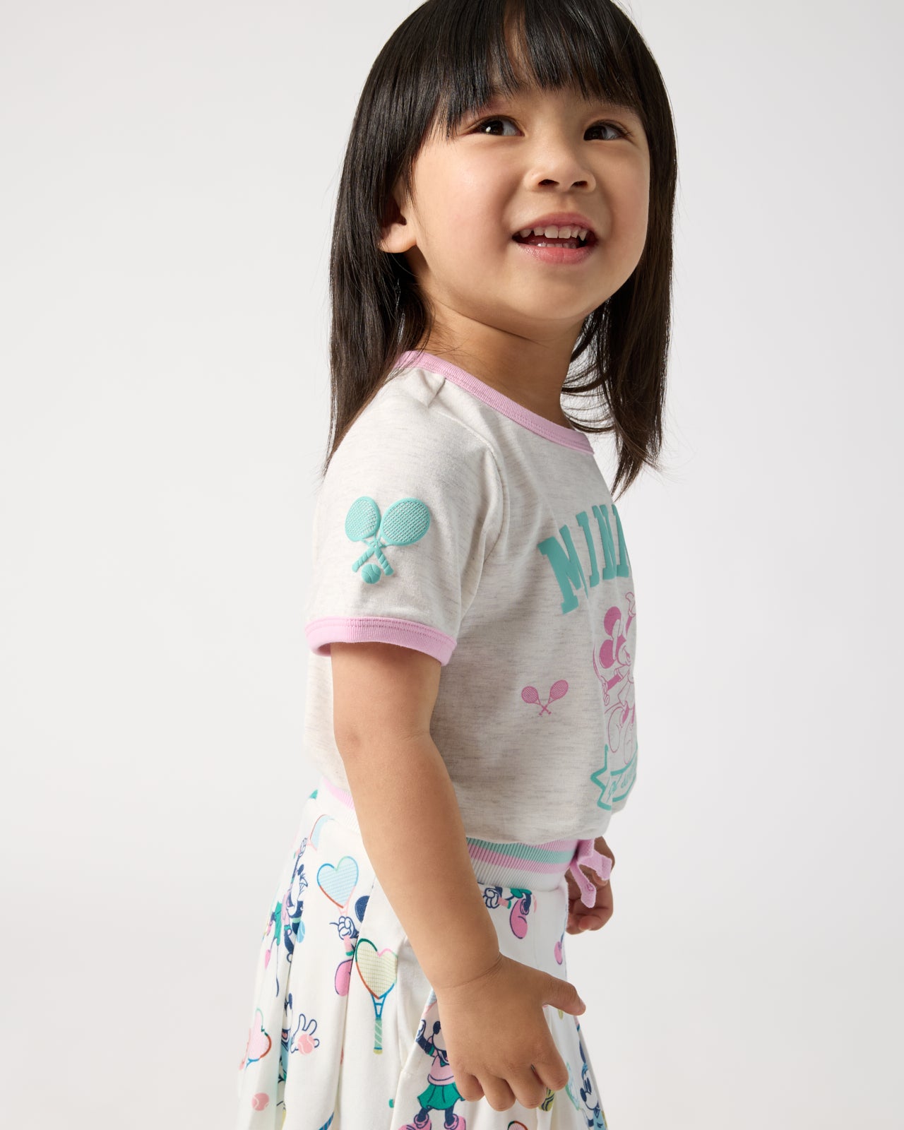 Side view of child wearing the Disney Minnie Mouse Queen of Swing Ringer Tee