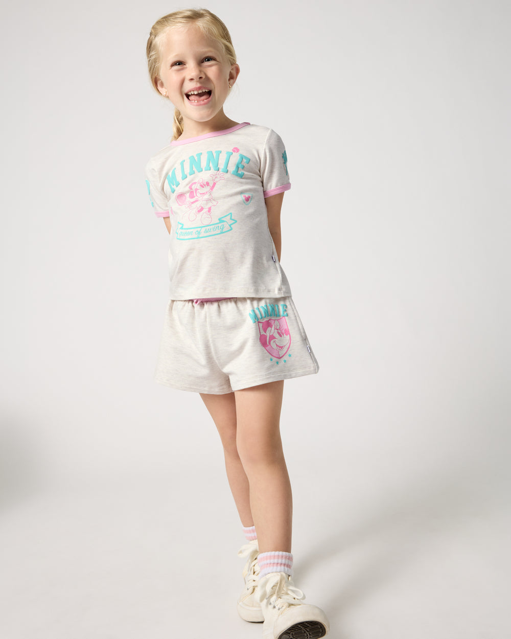 Girl wearing the Disney Minnie Mouse Queen of Swing Athletic Short and Tee