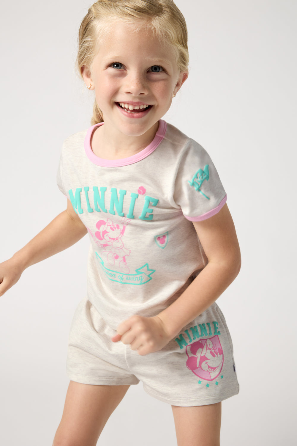 Girl wearing the Disney Minnie Mouse Queen of Swing Ringer Tee and Shorts