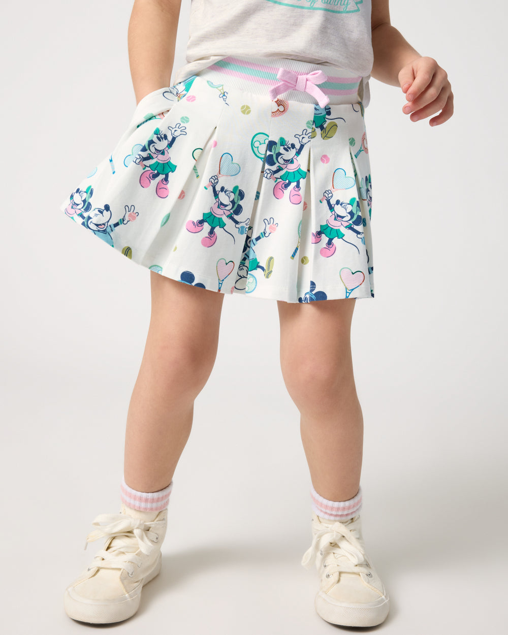 Girl wearing the Disney Mickey Mouse & Minnie Mouse Match Pleated Skort with white sneakers