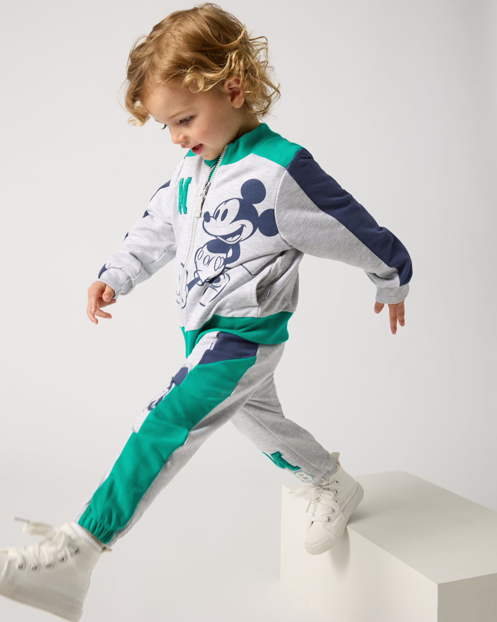 Child in motion wearing the Disney Mickey Mouse Sports Club Track Jacket and Joggers