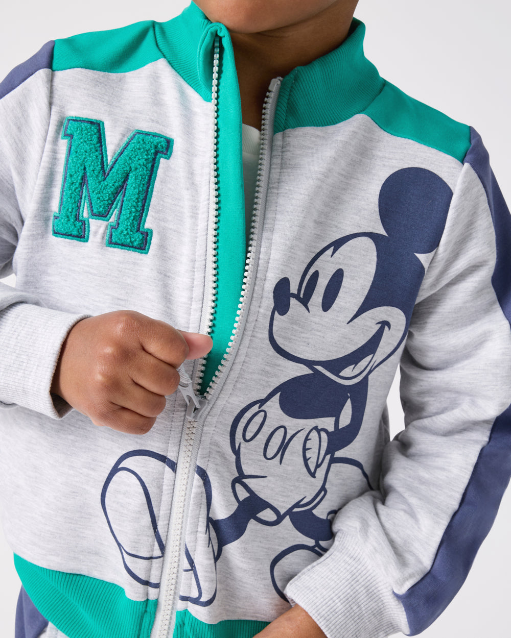Child zipping up the Disney Mickey Mouse Sports Club Track Jacket