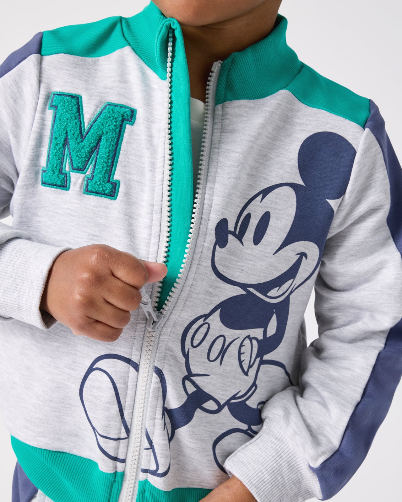 Child zipping up the Disney Mickey Mouse Sports Club Track Jacket