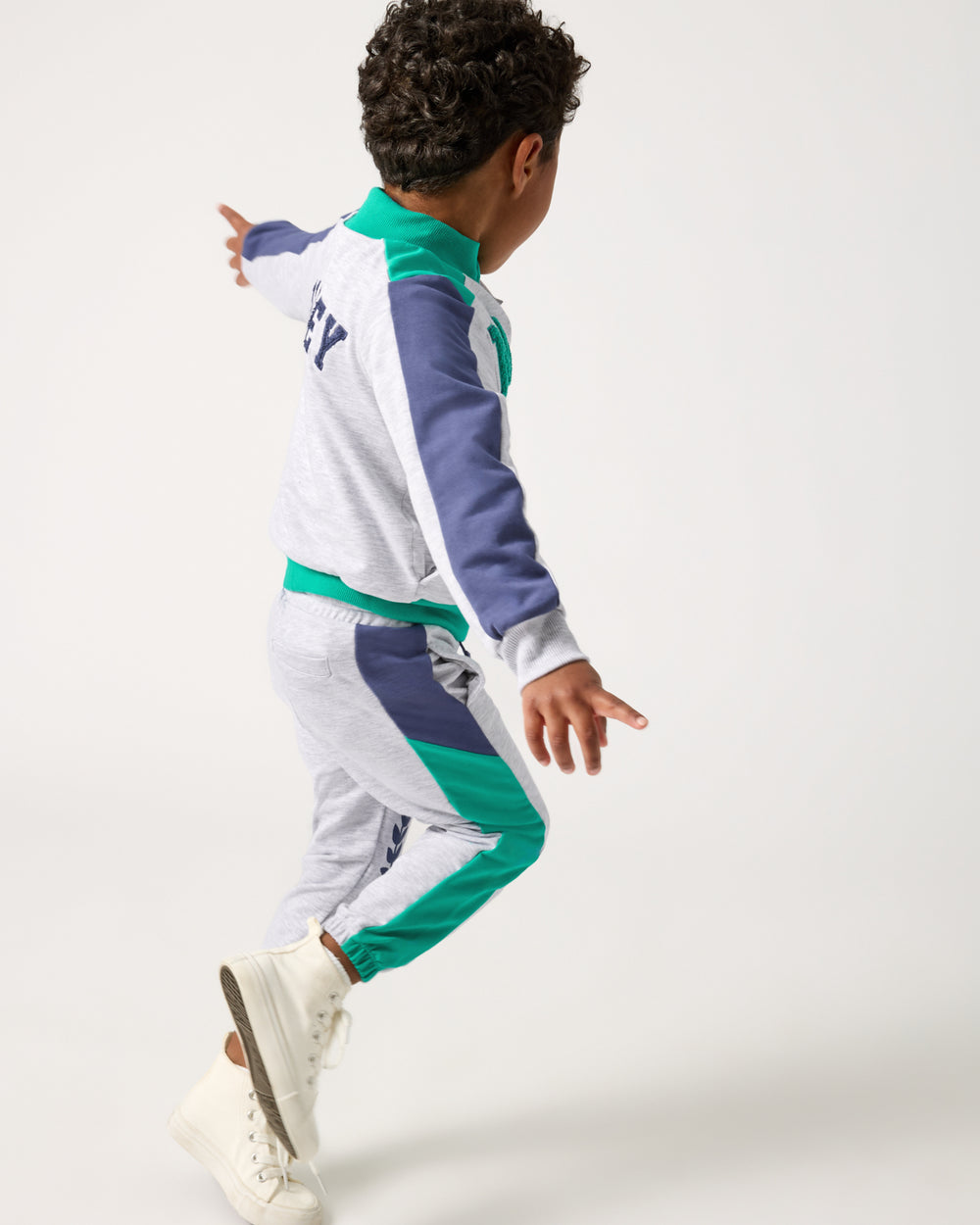 Running boy wearing the Disney Mickey Mouse Sports Club Panel Jogger and Jacket