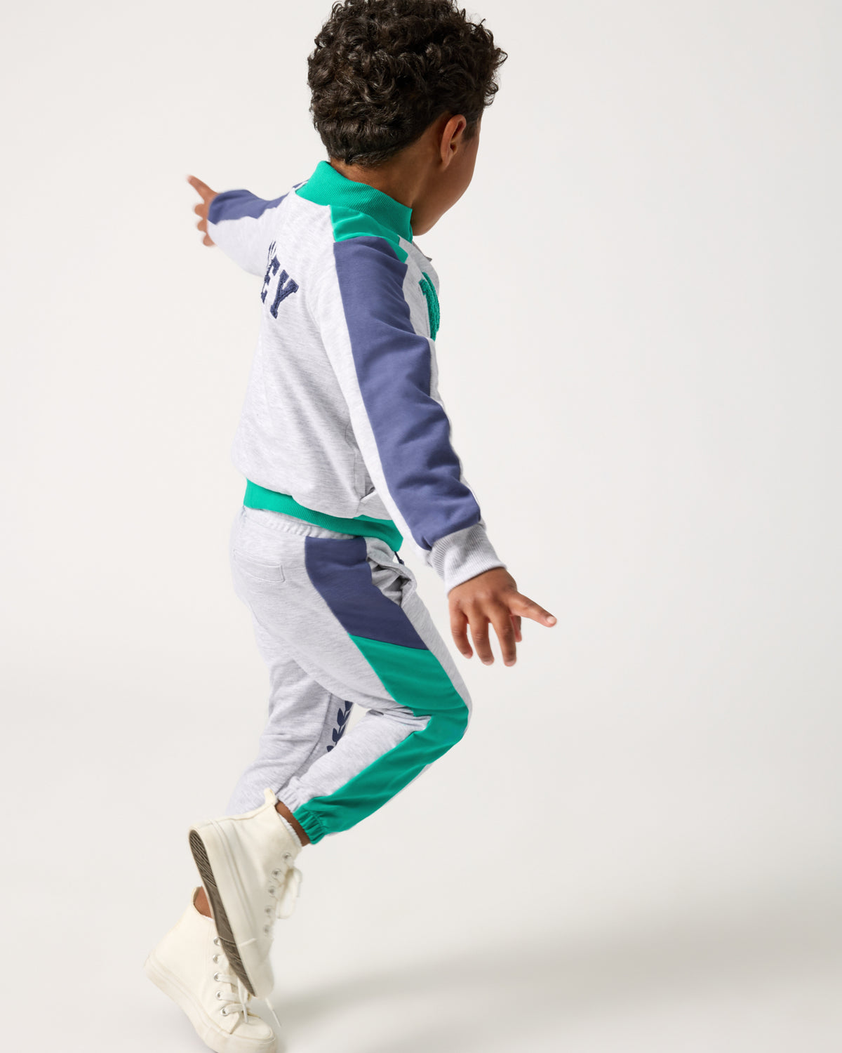 Running boy wearing the Disney Mickey Mouse Sports Club Panel Jogger and Jacket