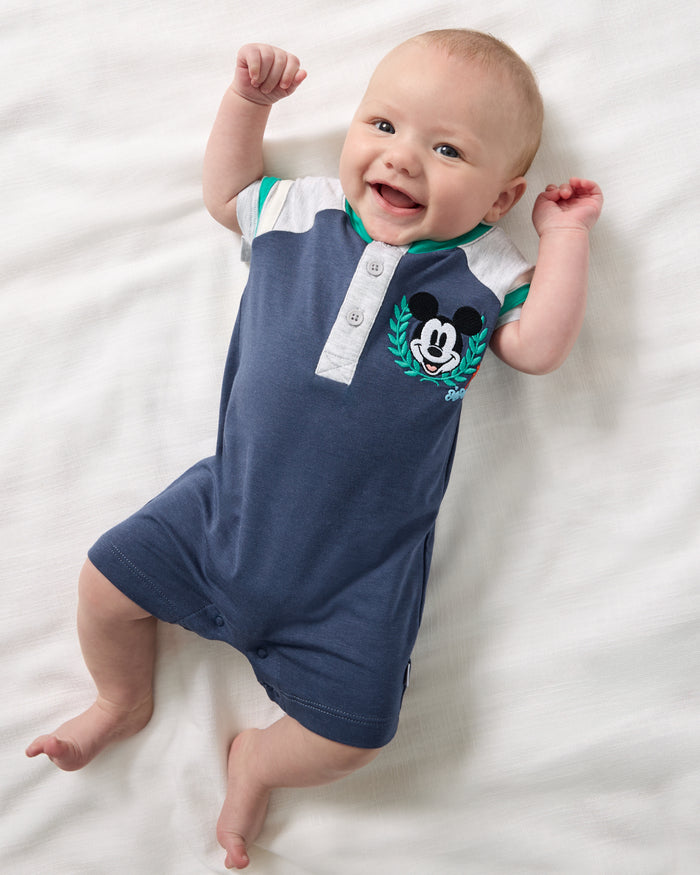 Aerial view of baby wearing the Disney Mickey Mouse Sports Club Henley Shorty Romper