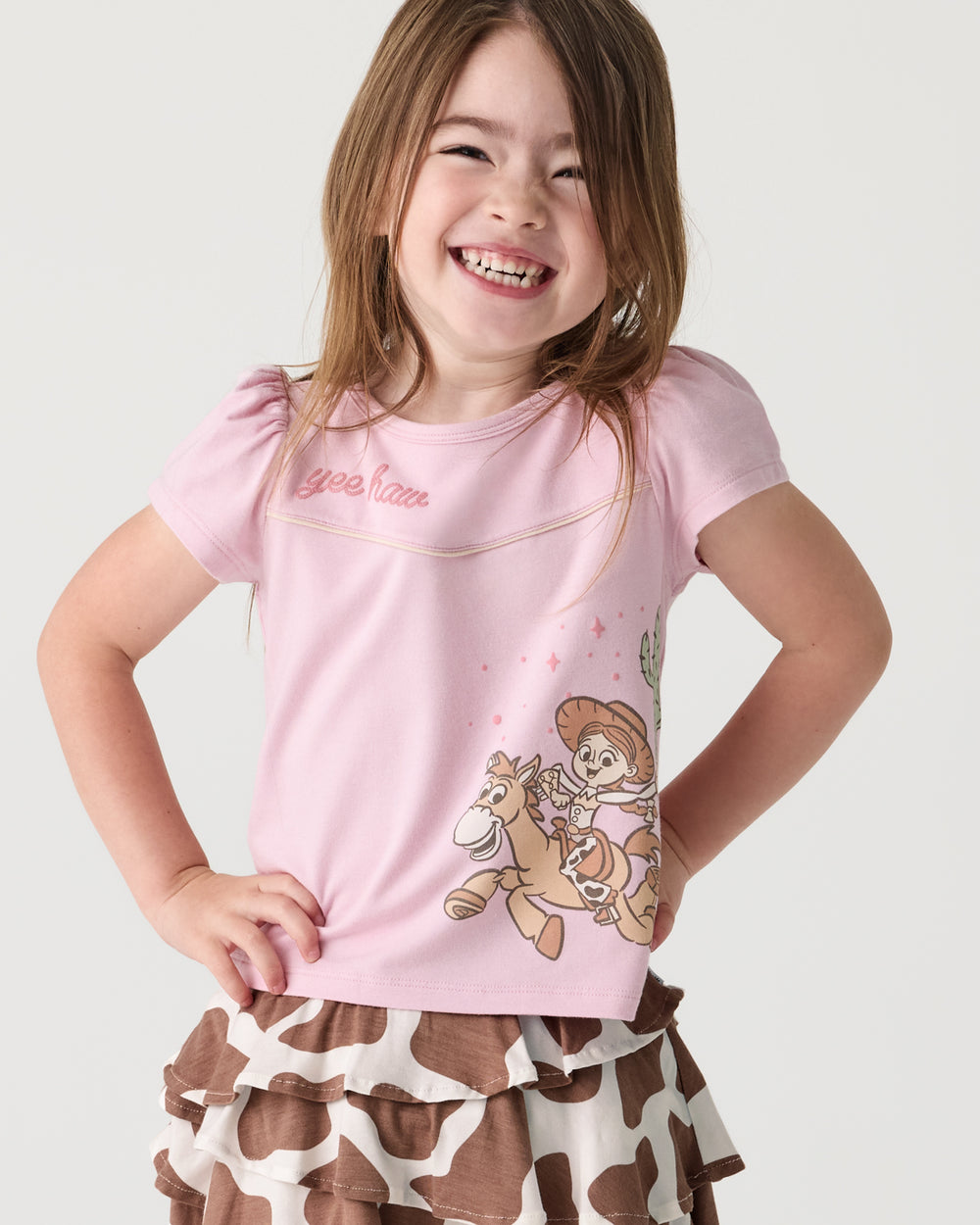 Girl wearing the Disney & Pixar Howdy Jessie Puff Sleeve Tee