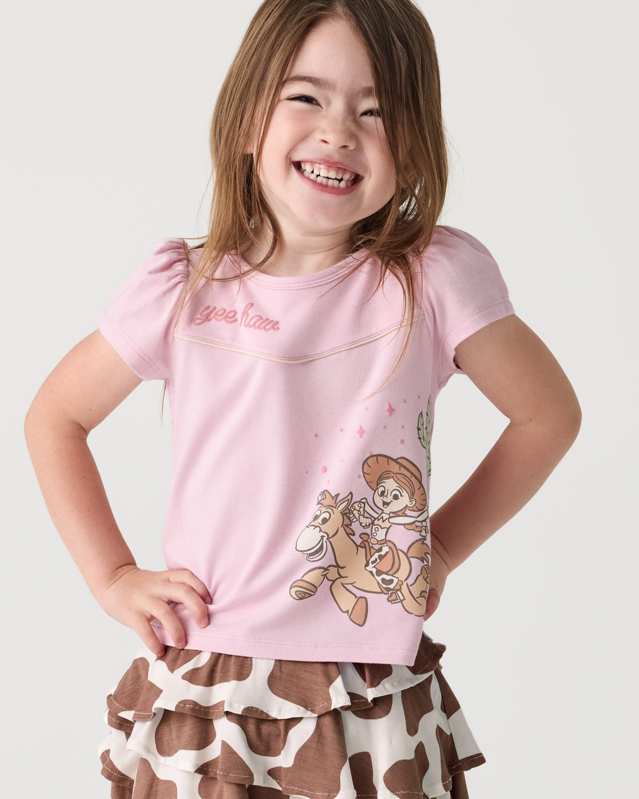 Girl wearing the Disney & Pixar Howdy Jessie Puff Sleeve Tee
