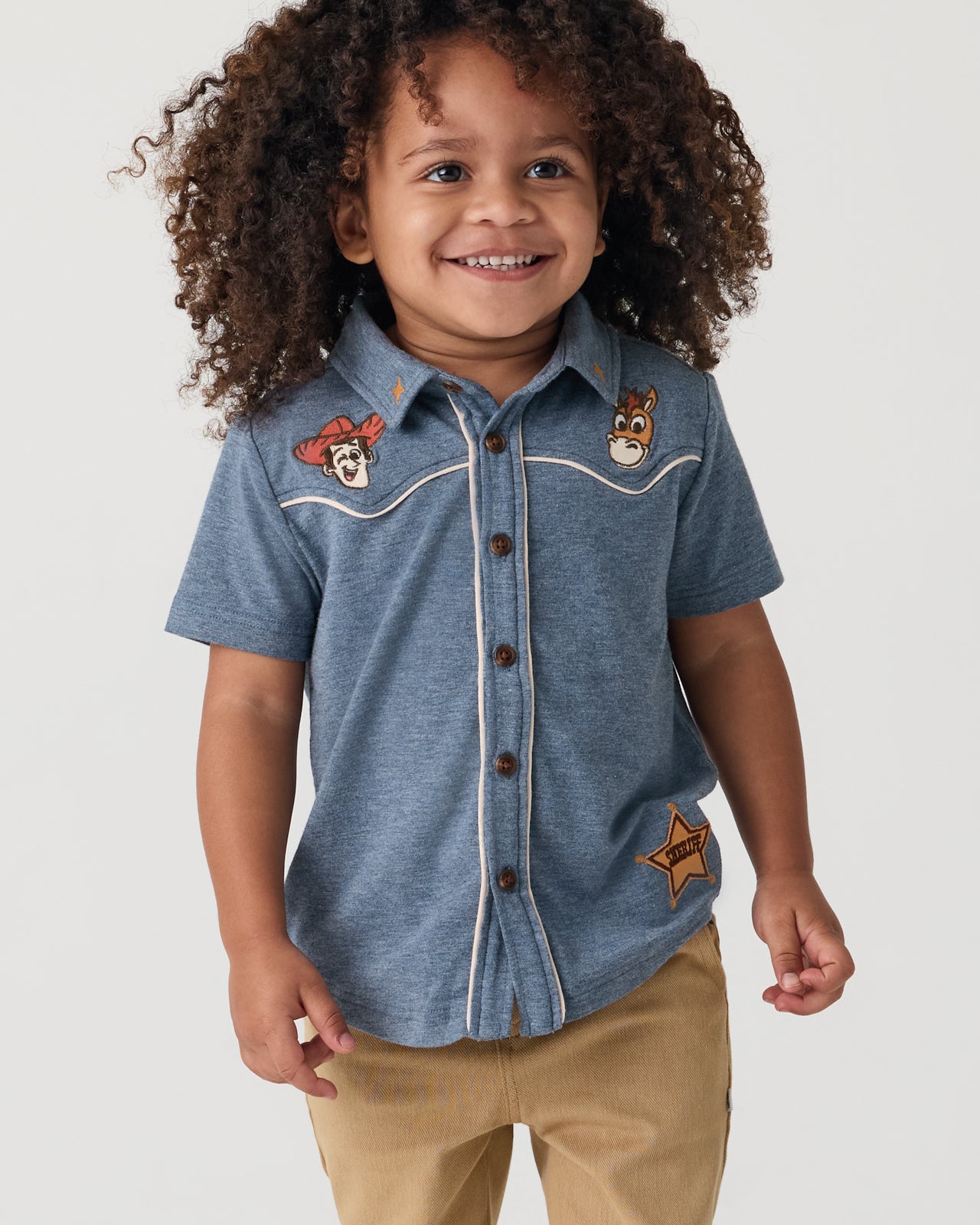 Child wearing the Disney & Pixar The Roundup Gang Button Down Polo