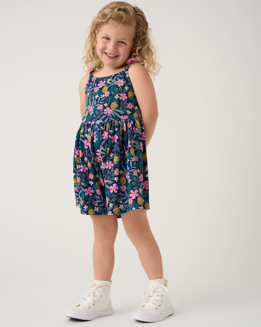 Girl wearing the Tropical Garden Bow Strap Romper