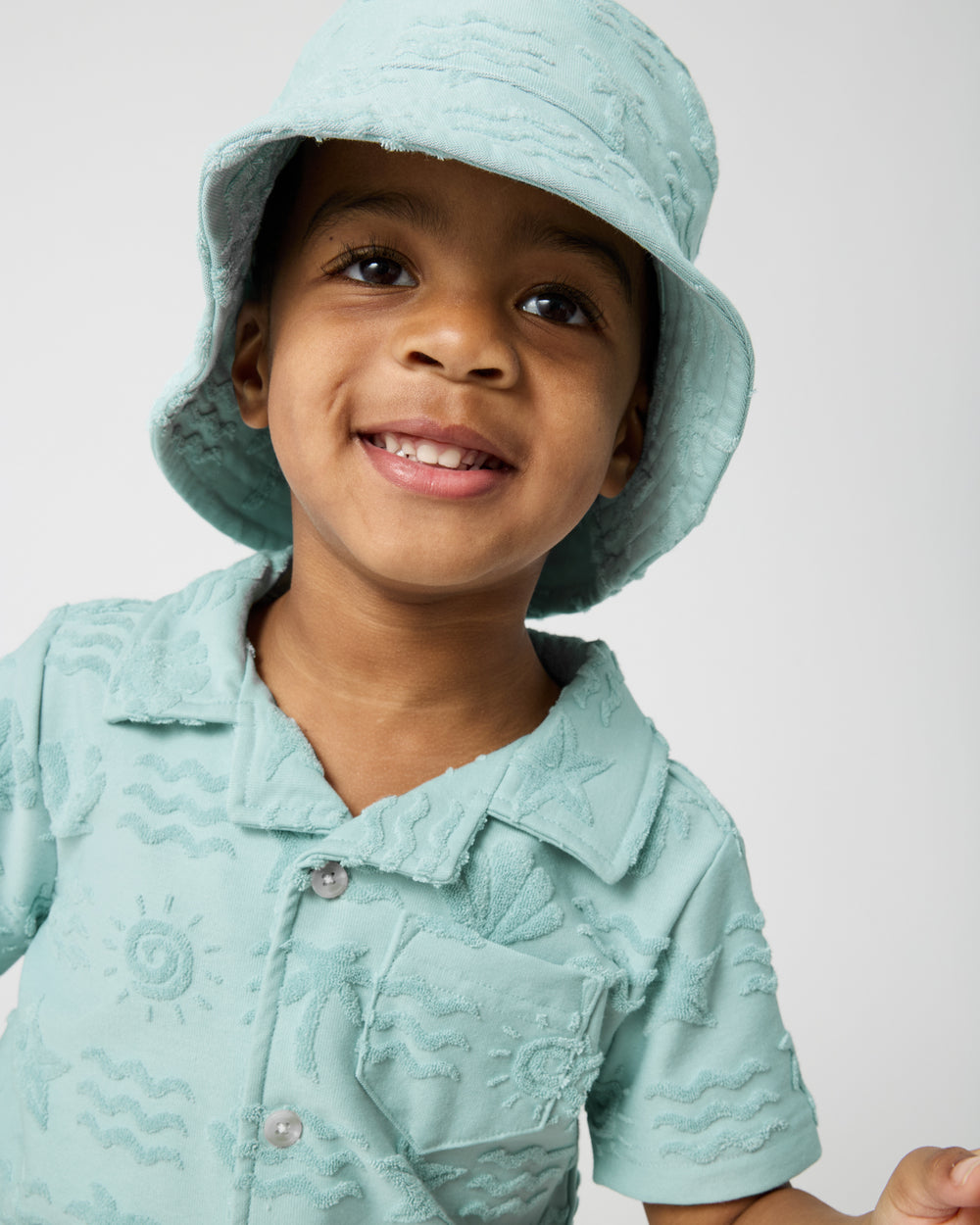 Close up of boy wearing the Coastal Rays Bucket Hat