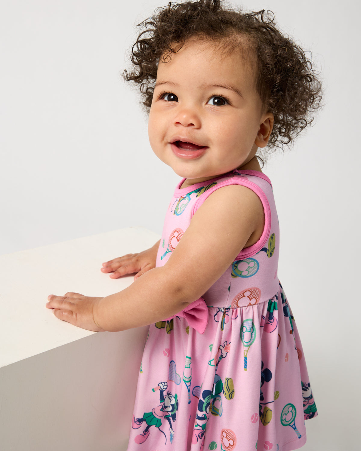Close up of baby wearing the Disney Mickey Mouse & Minnie Mouse Match Twirl Dress with Bodysuit