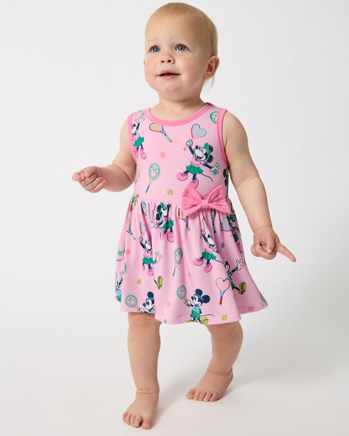 Walking baby wearing the Disney Mickey Mouse & Minnie Mouse Match Twirl Dress with Bodysuit