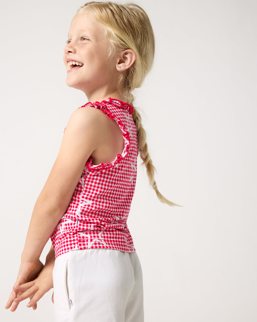 Side view of girl wearing the Celebration Gingham Ruffle Tank Top