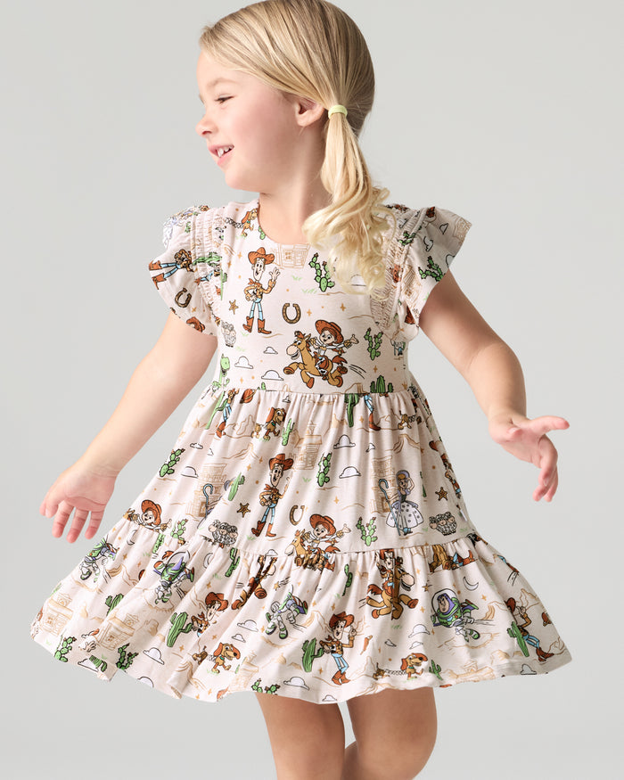 Girl wearing the Disney & Pixar Woody's Wild West Tiered Flutter Dress