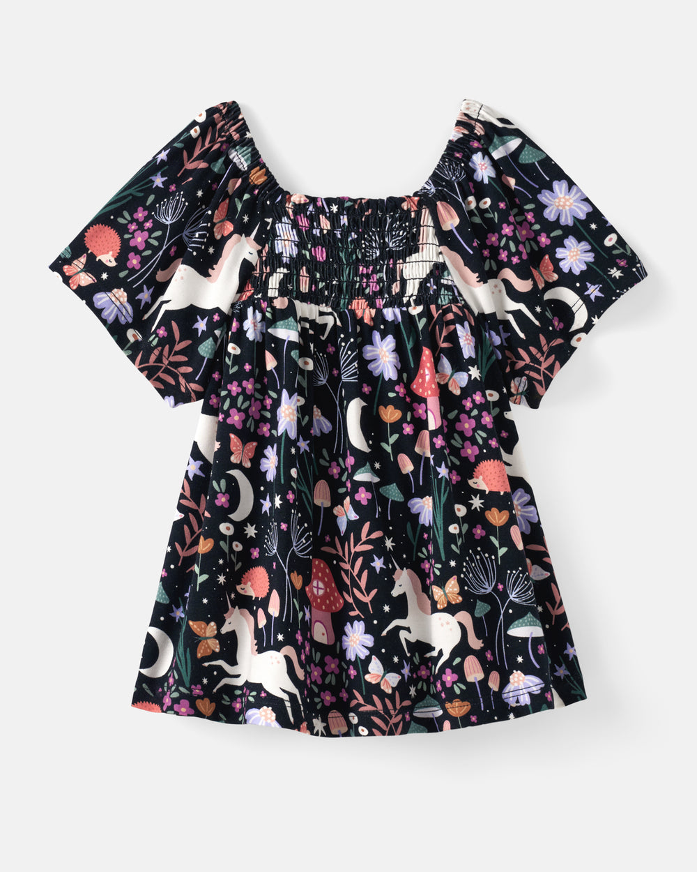 A girls' short-sleeve smocked blouse with a dark navy background and a whimsical multicolor print of unicorns, flowers, and mushrooms, shown flat on a light gray background.
