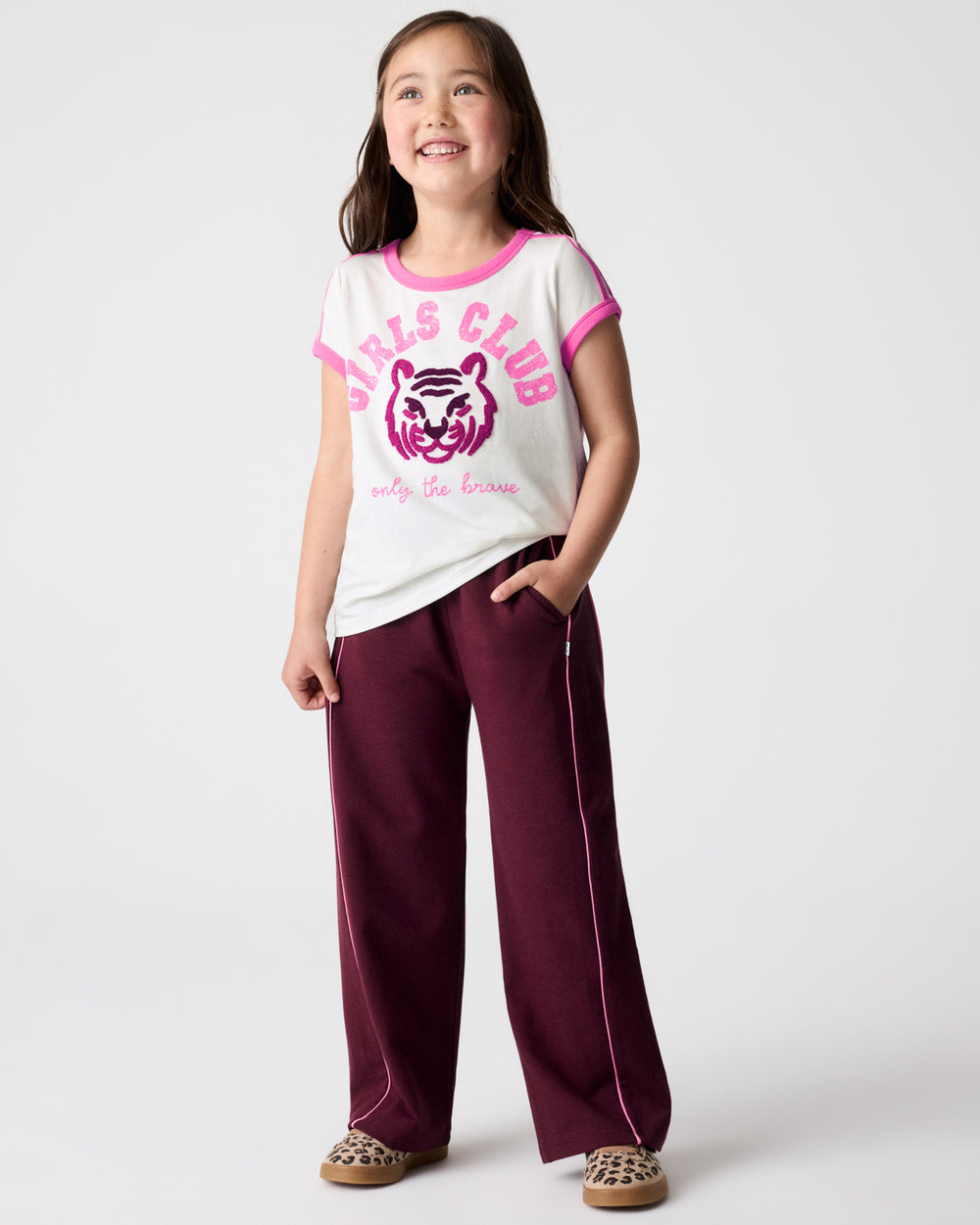 Girl wearing the Brave Tiger Scoop Neck Tee with maroon pants