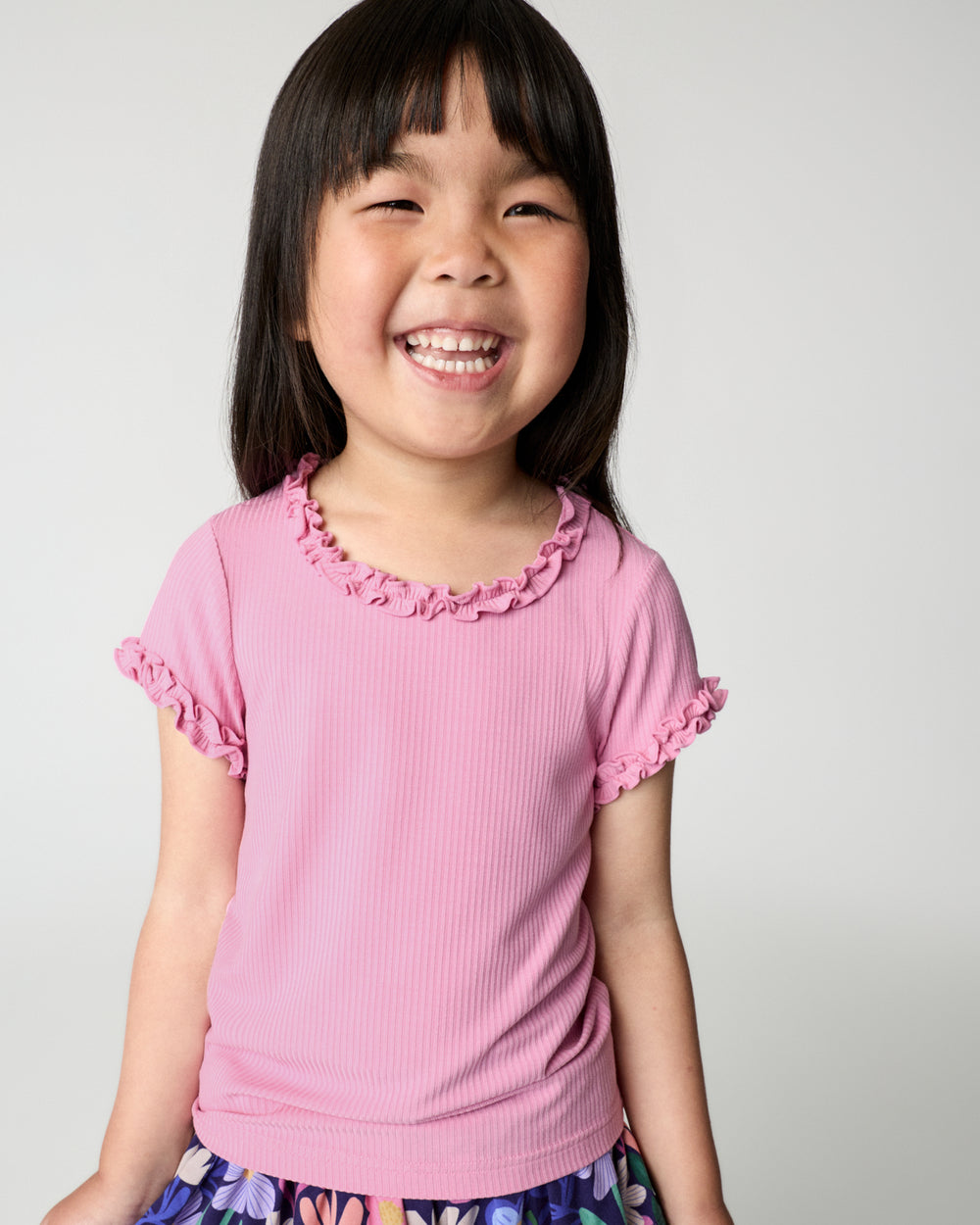 Girl wearing the Blush Orchid Ruffle Tee