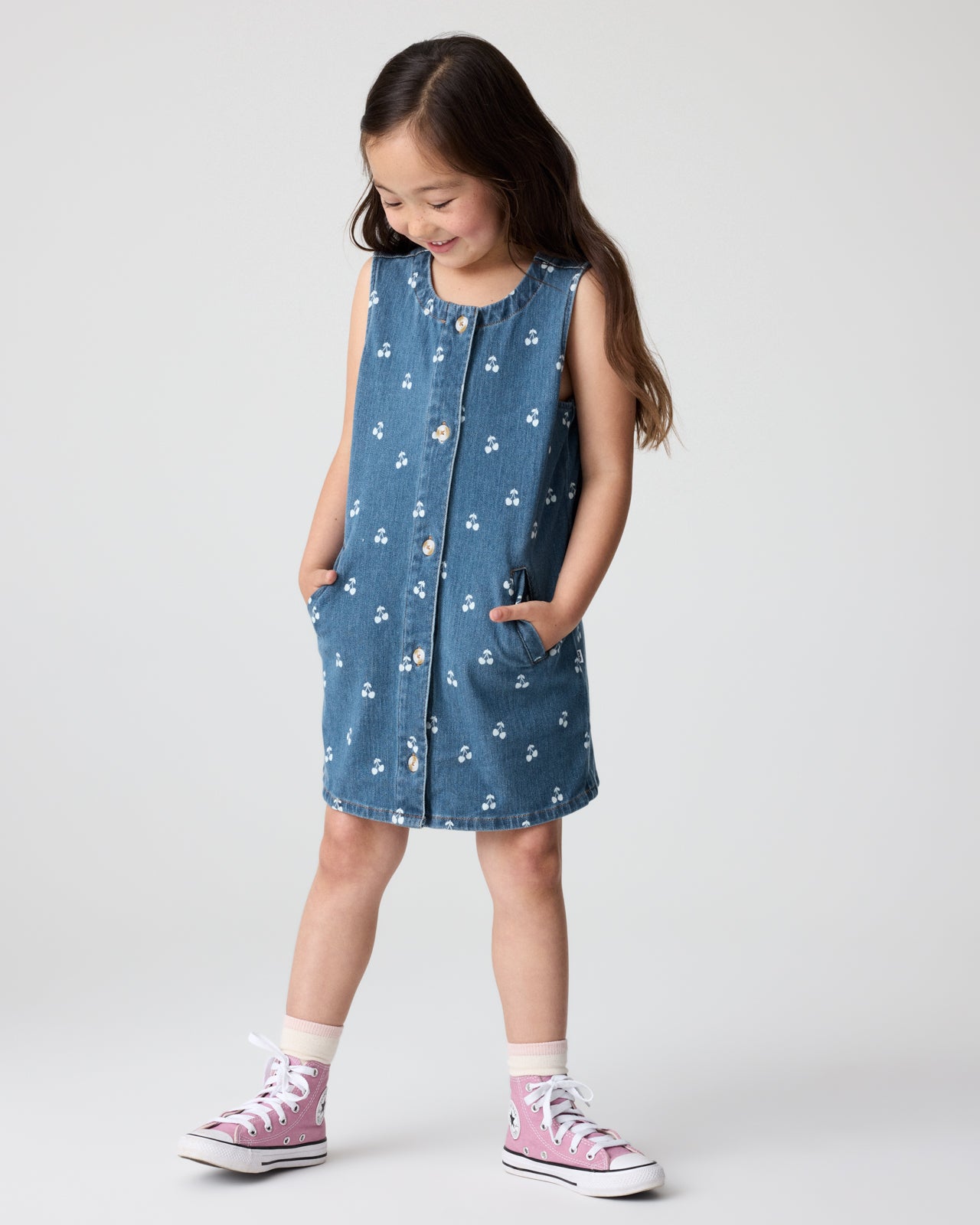 Front view of girl wearing the Cherry Button Down Denim Dress