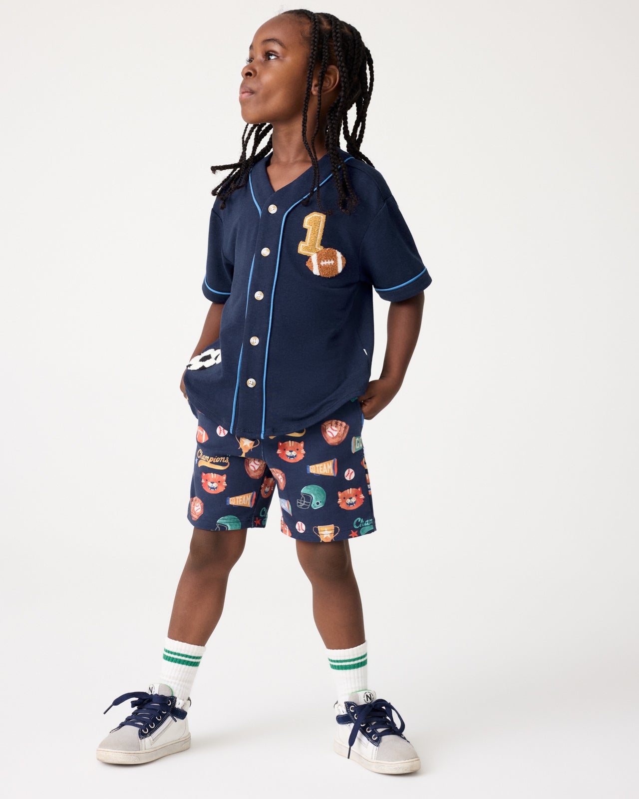 Boy wearing the Team Spirit Baseball Tee and Shorts