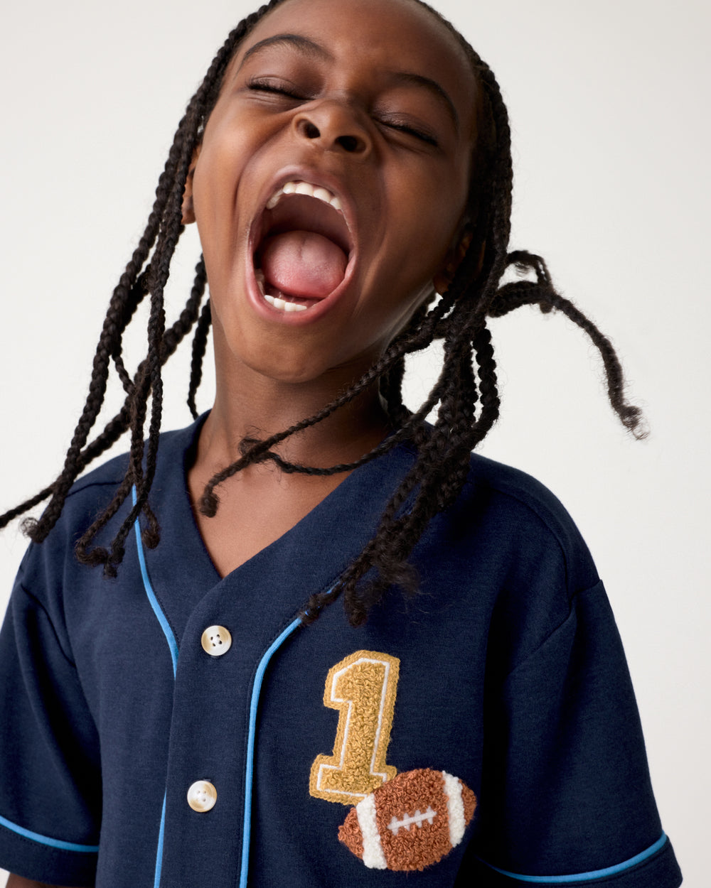 Close up of boy wearing the Team Spirit Baseball Tee